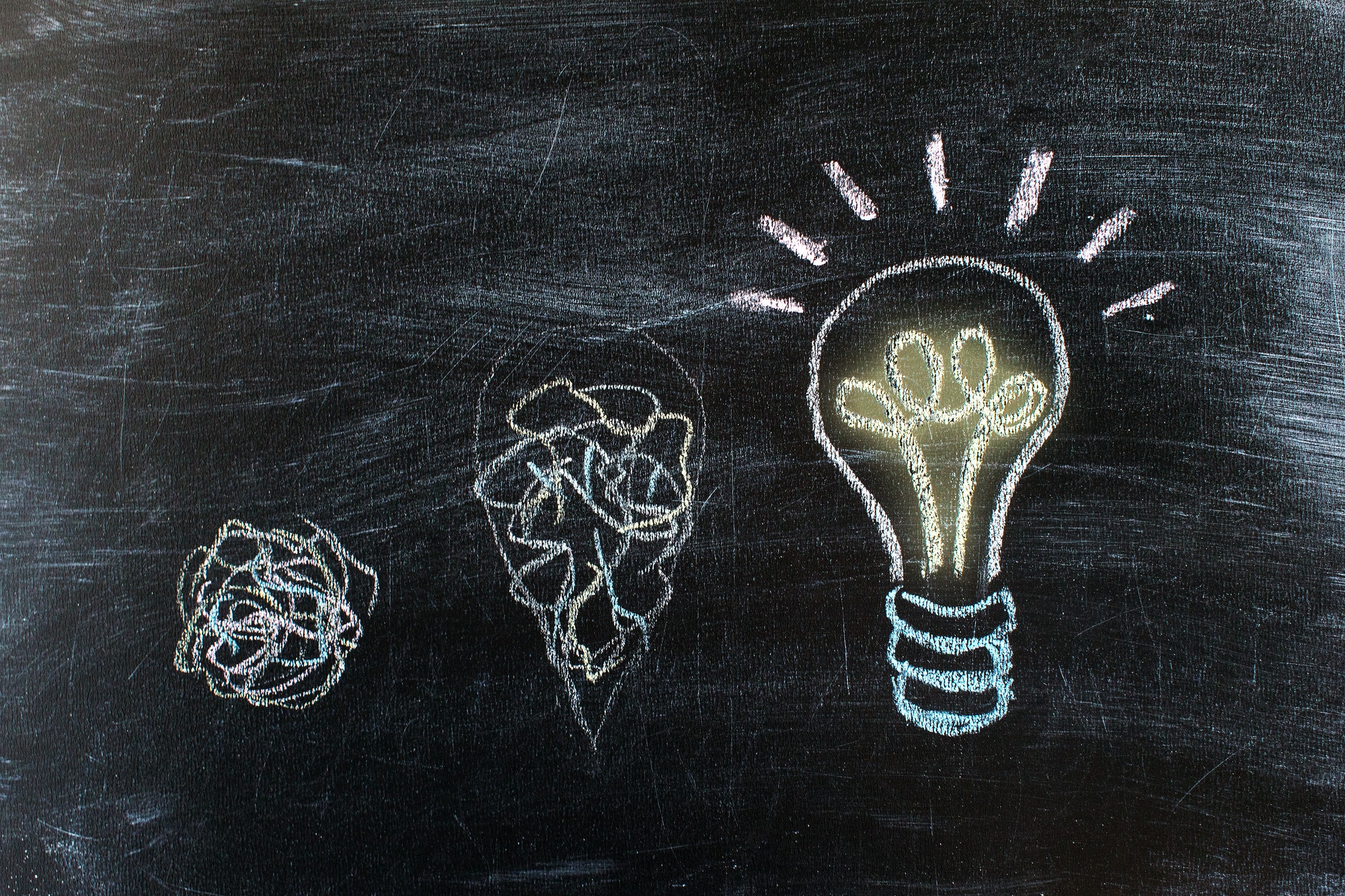 Chalkboard with Chalk Drawing of Hanging Light Bulb. Bright idea on blackboard concept. Way of
